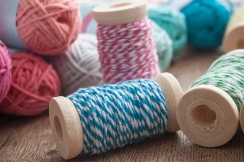 Sewing thread spool bobbin on wooden table background Stock Photos