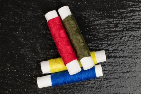 Sewing thread spool on grey stone Foto stock