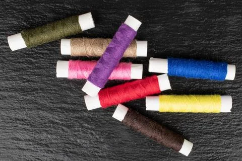 Sewing thread spool on grey stone Foto stock