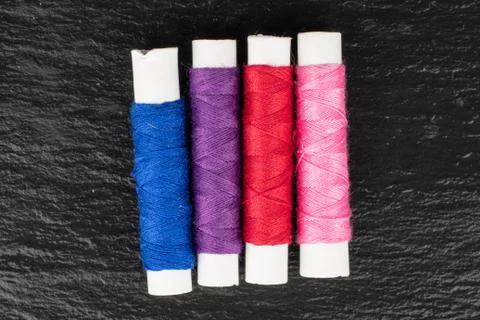 Sewing thread spool on grey stone 写真素材