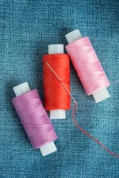 Sewing threads and needle closeup Stock Photos