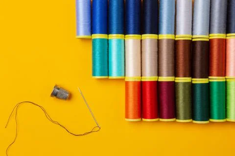 Sewing threads  and a needle thimble Stock Photos