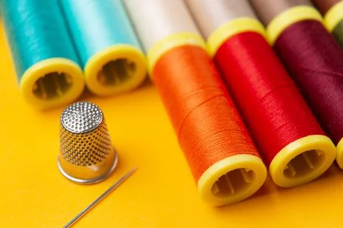 Sewing threads  and a needle thimble Stock Photos