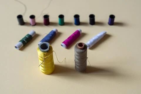 Sewing threads and needles studio shot. Fashion concept on a yellow background. 库存照片