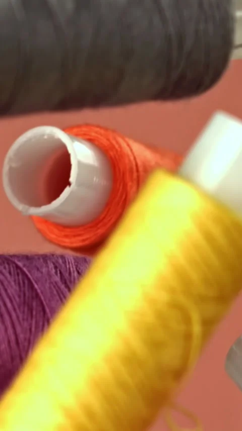Sewing threads fly on a red background. Filmed on a high-speed camera at 1000 Stock Footage 335384077