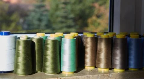 Sewing threads multicolored background closeup on the windowsill Stock Photos