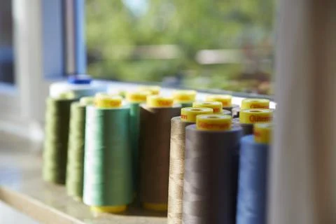Sewing threads multicolored background closeup on the windowsill Stock Photos