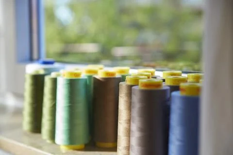 Sewing threads multicolored background closeup on the windowsill Stock Photos