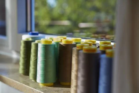 Sewing threads multicolored background closeup on the windowsill Stock Photos