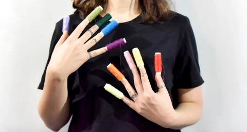 Sewing threads as a prolongation of fingers Stock Photos