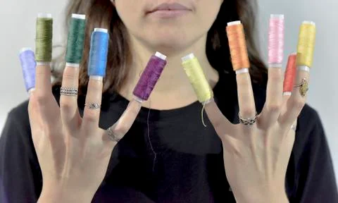 Sewing threads as a prolongation of fingers Stock Photos