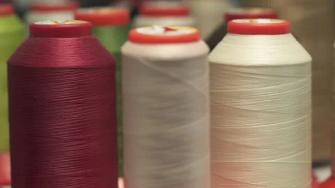 Sewing threads on spool. Colorful spools of thread. Dolly shot. Closeup. Stock Footage 234716481