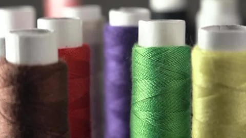 Sewing Threads On Spool. Extreme Closeup. Colorful spools of thread in textile Stock Photos