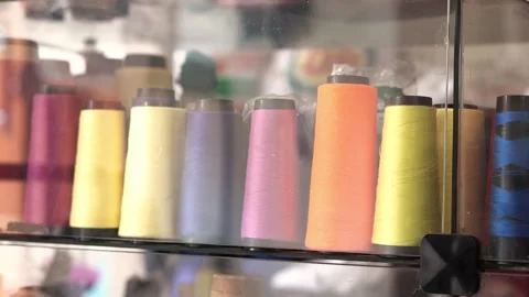 Sewing threads spools in a row. Colorful sewing supplies. Stock Footage 137679706