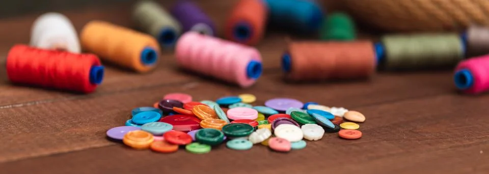 Sewing tool for needlework. Colored buttons. Close-up. Stock Photos