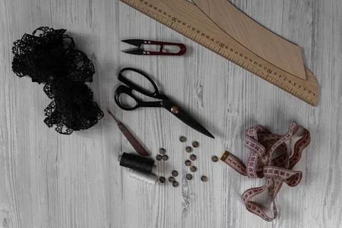 Sewing tools and accessories on table with scissors threads buttons and mea.. Stock Photos