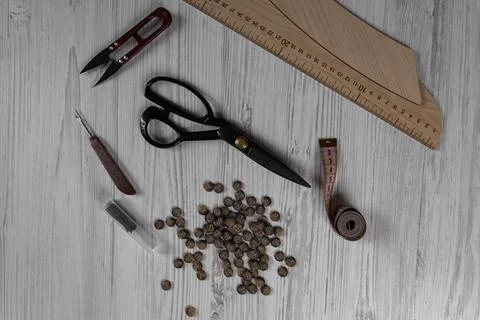Sewing tools and accessories on table with scissors threads buttons and mea.. Fotos de archivo