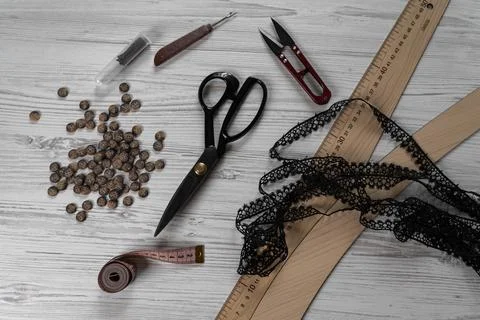 Sewing tools and accessories on table with scissors threads buttons and mea.. Stock-Fotos