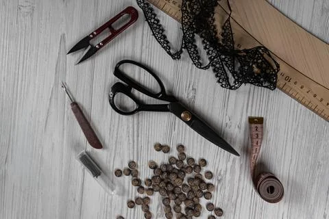 Sewing tools and accessories on table with scissors threads buttons and mea.. Stock-Fotos