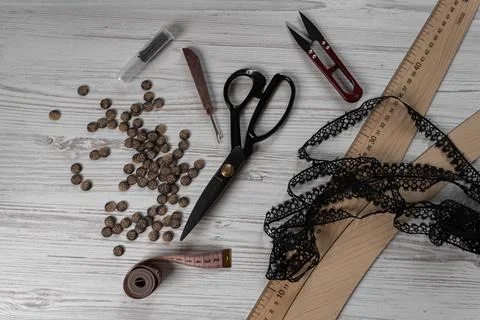Sewing tools and accessories on table with scissors threads buttons and mea.. Stock Photos