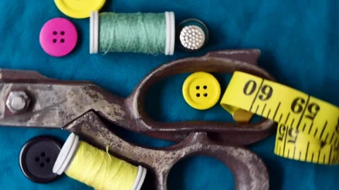 Sewing tools and threads rotate on a board Video stock 247247809