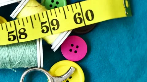 Sewing tools and threads rotate on a board Video stock 247337583
