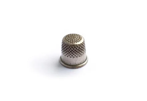 Sewing tools. An antique thimble on isolated on a white background Stock Photos