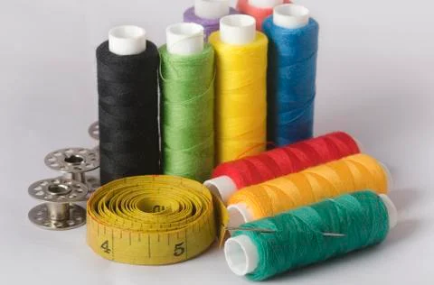 Sewing tools collection. thread sewing needle, measuring tape, bobbins, in a Stock Photos