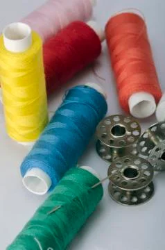 Sewing tools collection. thread, sewing needle, bobbins, in a white backgroun Stock Photos