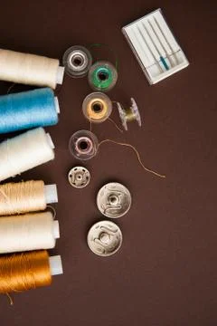 Sewing tools on the dark brown background with copy space Stock Photos