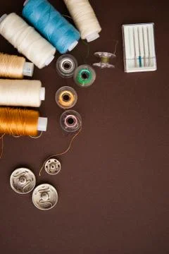 Sewing tools on the dark brown background with copy space Stock Photos