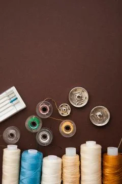 Sewing tools on the dark brown background with copy space Stock Photos