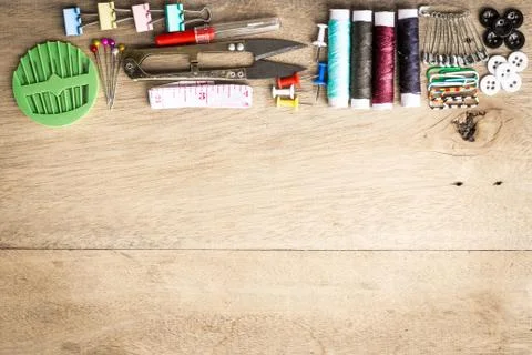 Sewing tools equipment space for sample text wood background Stock Photos