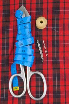 Sewing tools: large scissors, measuring tape wound on a pair of scissors, a s Stock Photos