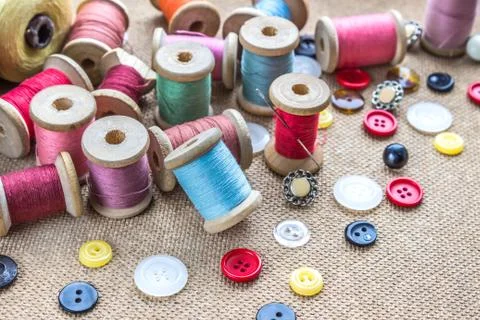 Sewing tools (many different colorful thread, needle, many different buttons) Stock Photos