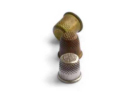 Sewing tools. Three copper antique thimbles isolated on a white background Stock Illustration