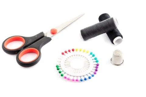 Sewing tools: two thread, scissors, pins and thimble Stock Photos