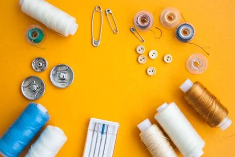 Sewing tools on the yellow background with copy space in center Stock Photos