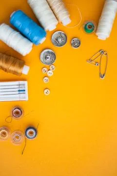 Sewing tools on the yellow background with copy space Foto stock