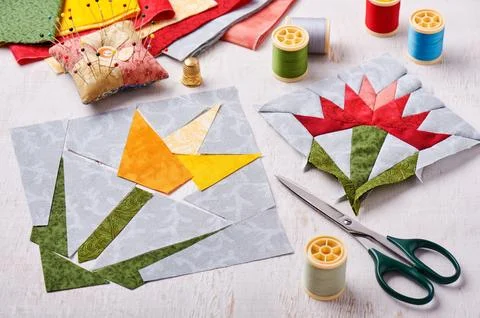 Sewing two patchwork blocks of flowers from quilt fabric Fotos de archivo