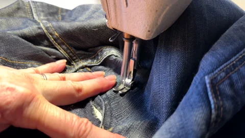 Sewing work. Stitching a hole in jeans with a sewing machine. Stock Footage 255925702