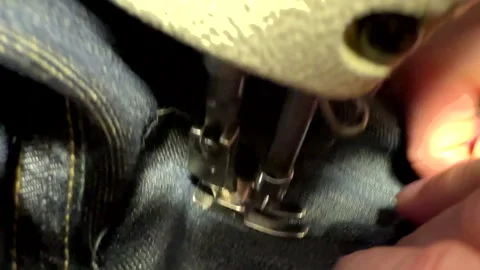 Sewing work. Stitching a hole in jeans with a sewing machine. Stock Footage 255926046