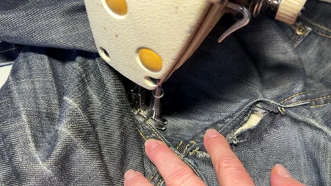 Sewing work. Stitching a hole in jeans with a sewing machine. Stock Footage 255926267