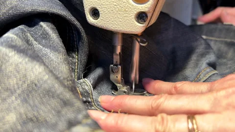 Sewing work. Stitching a hole in jeans with a sewing machine. Stock Footage 255926327