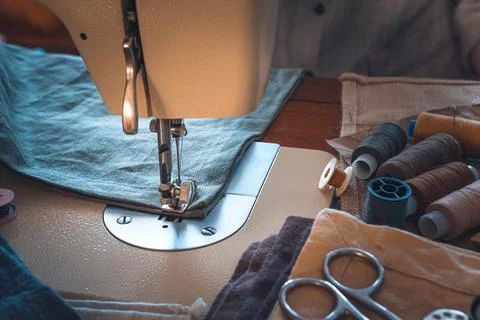 Sewing workplace with a sewing machine. Side view Stock Photos