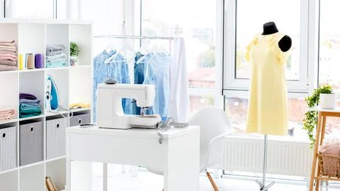 Sewing Workshop With Fabrics And Sewing Machine Stock Photos