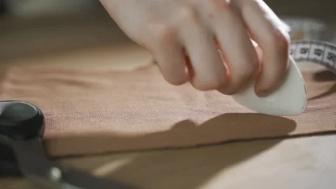 Sewing workshop with sunlight. Creative work, making clothes. Shot from the side Stock Footage 143910507