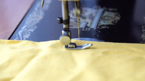 Sewing a yellow cloth Stock Footage 98457938
