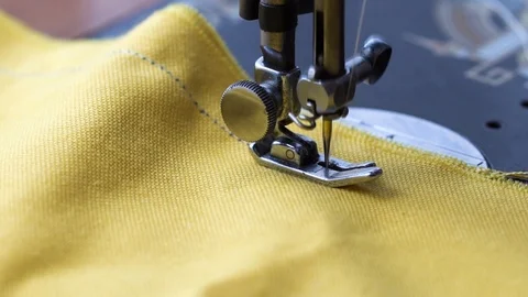 Sewing a yellow cloth Stock Footage 98458438