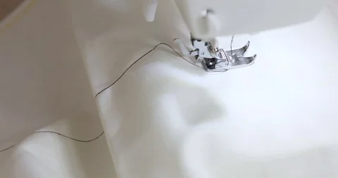 Sewing a zig zag pattern with a sewing machine  on the white fabric then Stock Footage 105232280